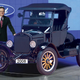 A Ford spokesman poses with the once-revolutionary automobile in a Michigan showroom.